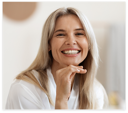 Woman grinning with CEREC same day dental crowns in Nocatee