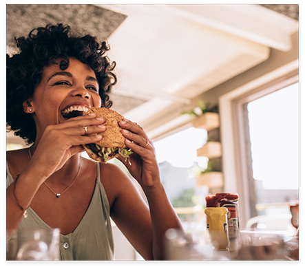 Woman taking a bite of a burger