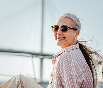 Senior woman smiling while relaxing on boat