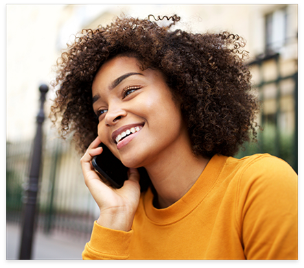 Woman in yellow sweater talking on phone