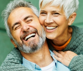 Senior couple hugging and laughing together