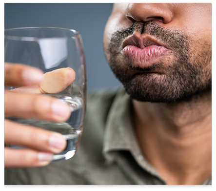 Man swishing water around in his mouth