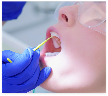 Dental patient having fluoride applied to their teeth
