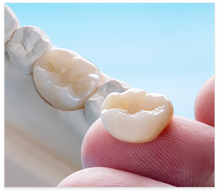 Close up of a dental crown on a finger