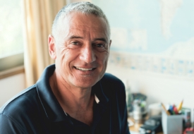 Smiling older man in navy blue polo shirt