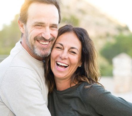 Couple smiling with veneers